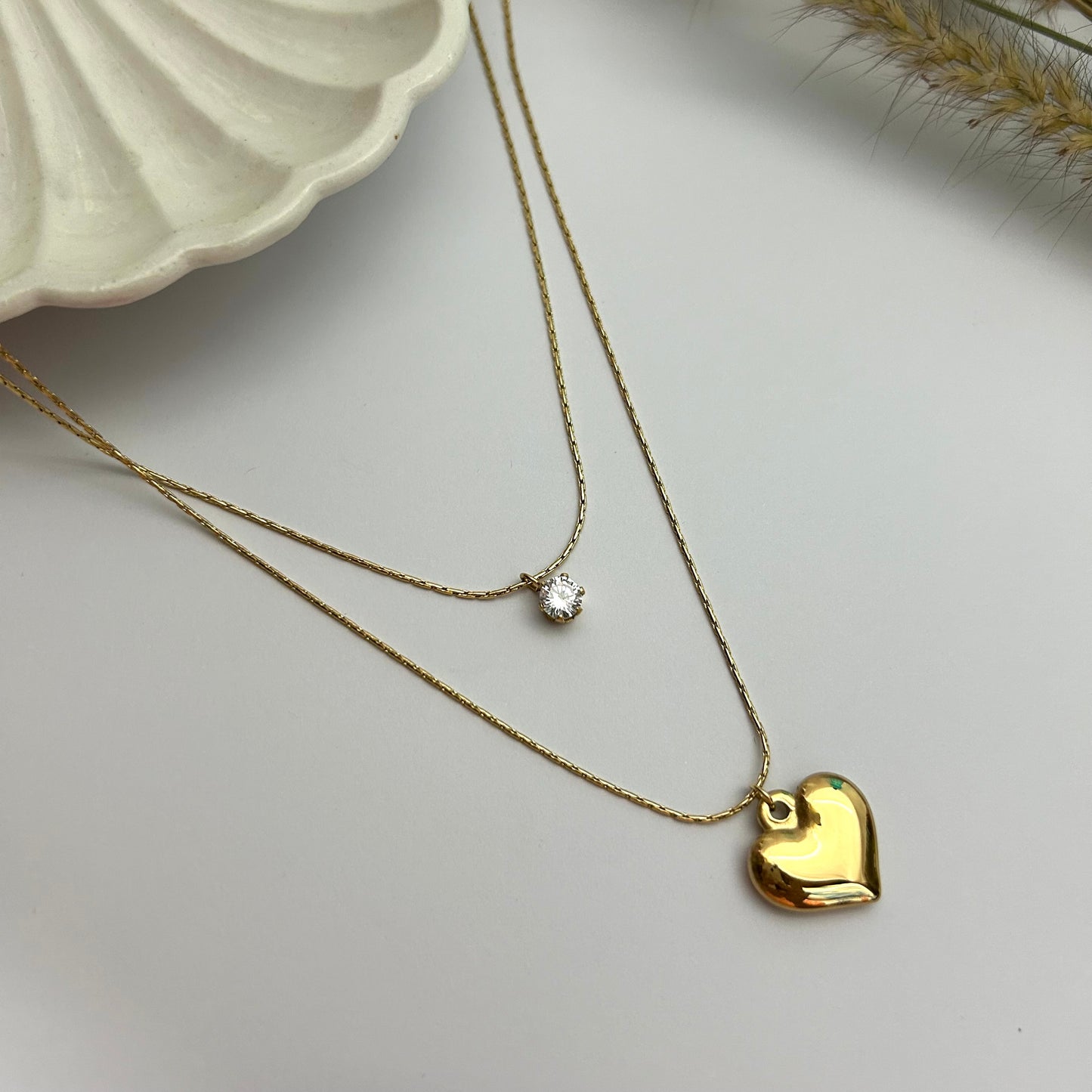 Dual heart necklace with tiny stone